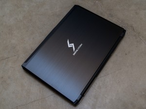 The Digital Storm Triton has a simple Clevo design with black plastic and black brushed metal accents.